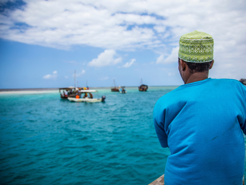 Beaches Zanzibar - Lets Discover Africa Traditional dhow boats sailing in the turquoise waters of Zanzibar, Tanzania